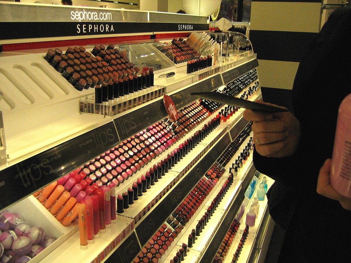 Wall of lipsticks and lip gloss on display at a Sephora makeup counter